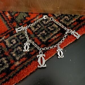 Cute silver tone bracelet with charms